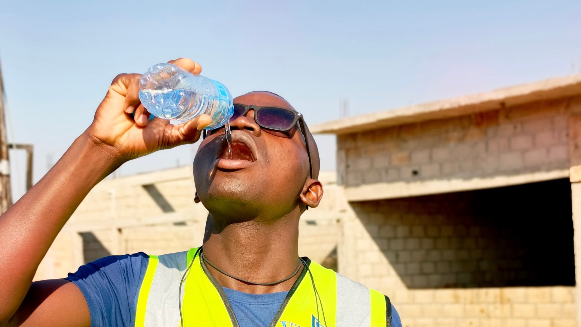 Construction worker drinking water on a hot day - California heat illness prevention